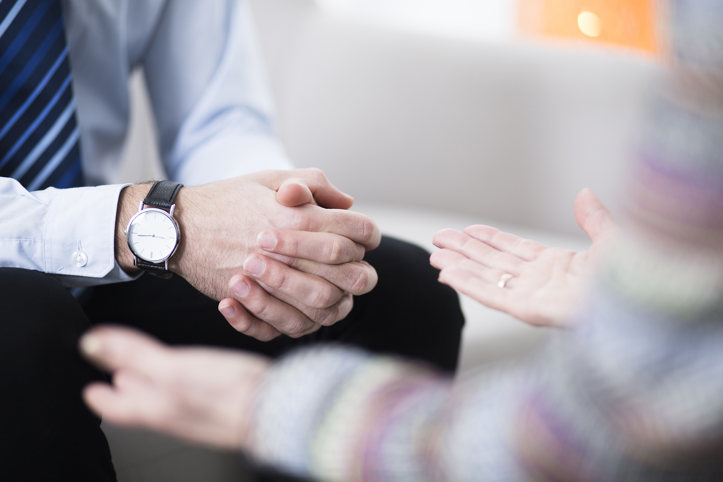 Close up of two people's hand during a conversation