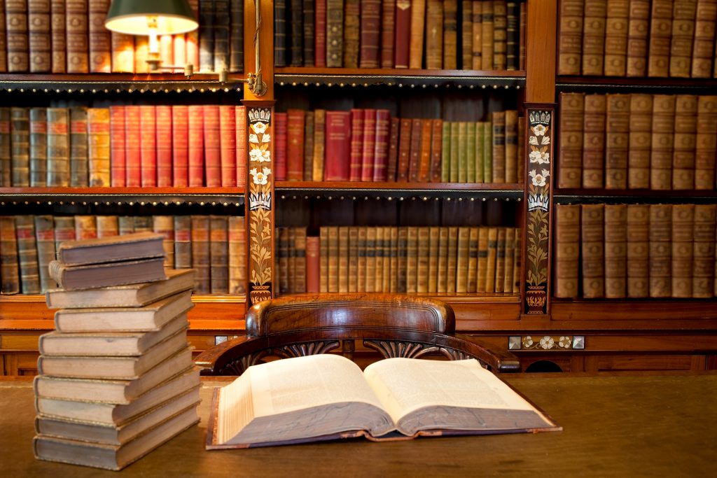 Old classic library with books on table A book open on a table in a law library